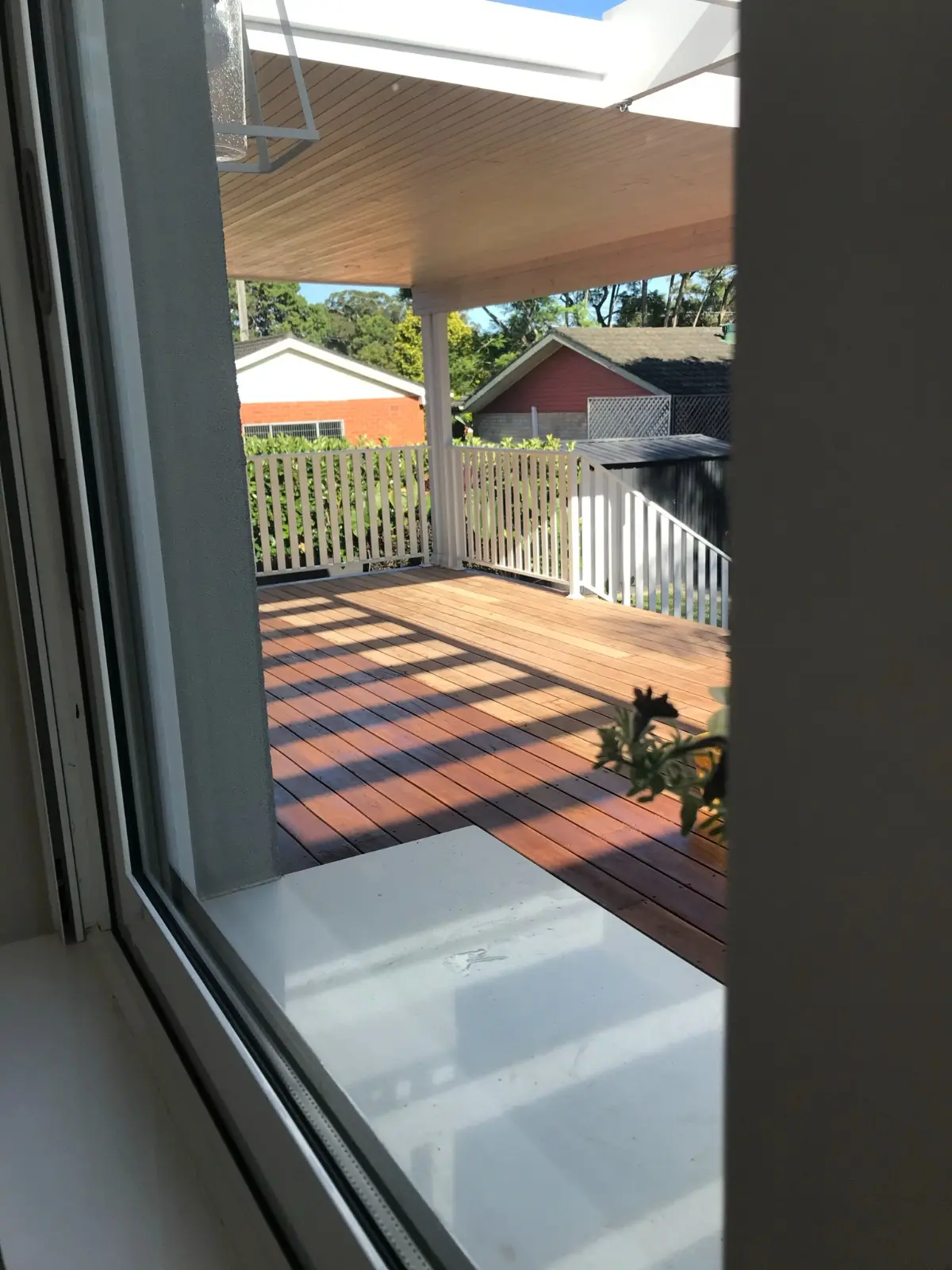 Inside-out connection — looking out onto the finished sunlit alfresco deck